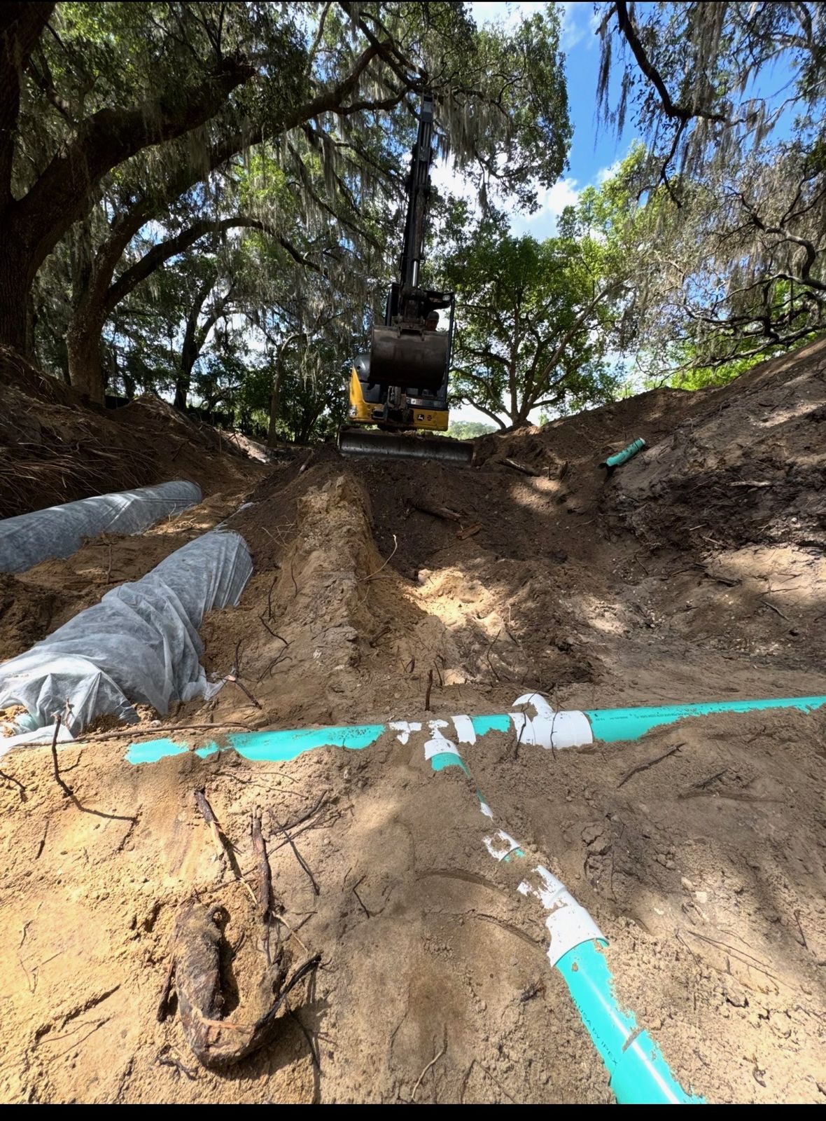 Bonded Septic Tank technician repairing a septic line in an excavated trench